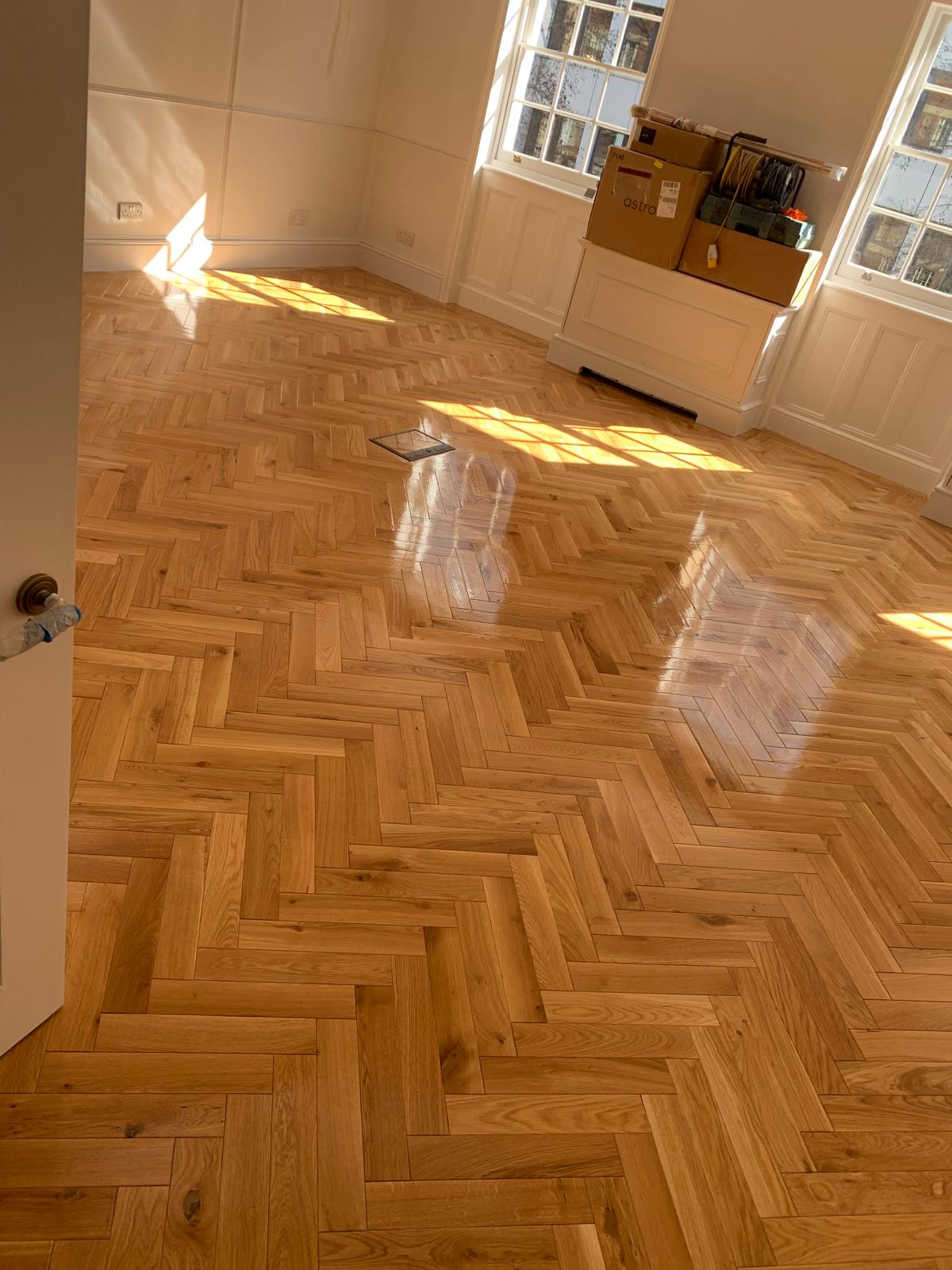 Herringbone wood floor installation, sanded and finished